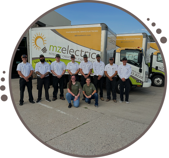 MZ Electric in front of work vans